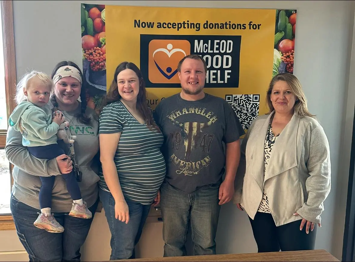 group of people standing together at a food shelf